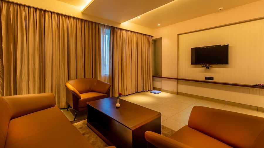 An image of a seating area with sofas, complemented by a television in front at M Pro Palace.